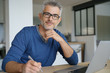© goodluz - Middle-aged man working from home-office on laptop