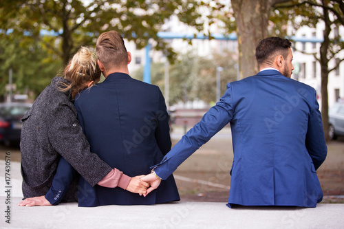 Fotografie, Obraz couple hugging while the woman holding hands with another man