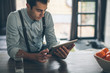 © MosunoMedia/Stocksy - Handsome Man Browsing Tablet Computer in the Morning