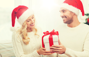 Poster - happy couple at home with christmas gift box