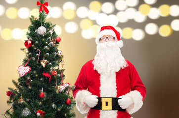 Wall Mural - santa claus at christmas tree