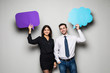 © F8  \ Suport Ukraine - Beautiful young couple is holding speech bubbles, looking at camera and smiling, on gray background