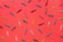 Colorful Paperclips On Red Background