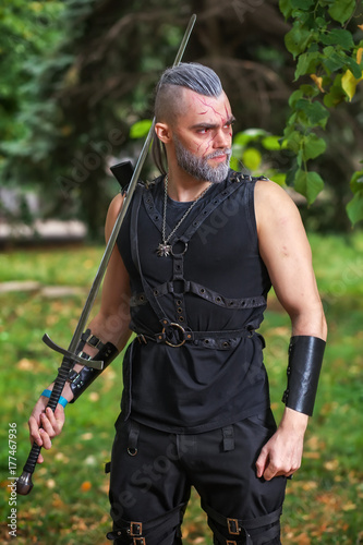 Cosplay character, dressed like a Geralt of Rivia from the game The Witcher Poster