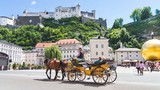 Fototapeta  - Tourists sightseeing in horse carriage in Salzburg, Austria