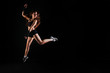 © yolya_ilyasova - Athletic girl in sport top jumping on black studio background. Fitness concept with copy space.