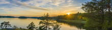 Panorama Picture Taken In Sweden With Sunset Over A Lake And Beautiful Glow From The Sun