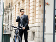 © Sergey Nivens - Young businessmen with a bike
