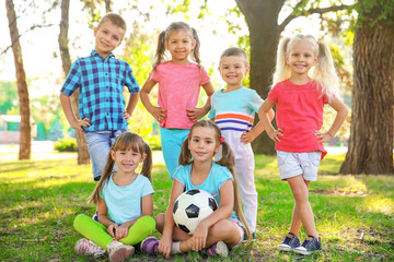 Poster - Cute little children with ball in park