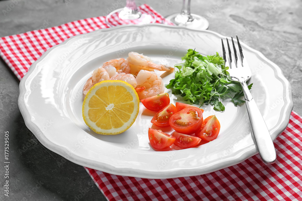 Plate with fresh tasty shrimp salad on table