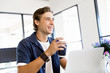 © Sergey Nivens - Young businessman in office with a mug