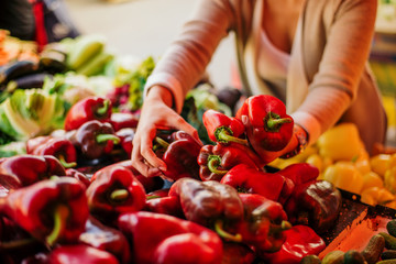 Woman choosing vegetables at the market.