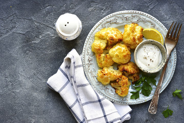 Wall Mural - Oven baked cauliflower with yogurt sauce.Top view with copy space.