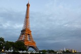 Fototapeta Paryż - Eiffel tower illuminated with the sun at night, in Paris, France