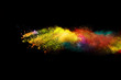 Explosion of colored powder on black background.