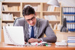 © Elnur - Young businessman addicted to online gambling cards playing in t