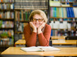 © Ermolaev Alexandr - Happy senior woman in library