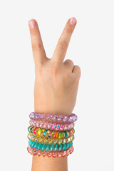 Baby hand with bracelets showing two fingers in top isolate