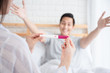 © chompoo - Selective focus Pregnancy test positive result on hand of smiling woman in her bedroom,Blurred background of her glad couple on the bed.