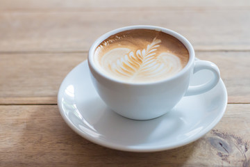 Coffee in a cup on a wooden table horizontal