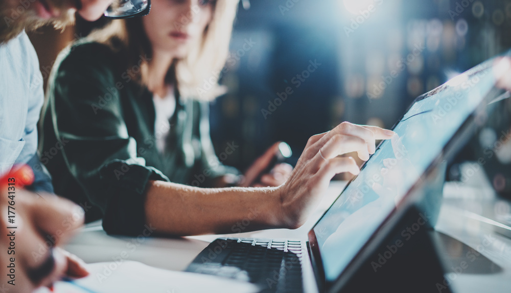 Woman pointing on digital tablet screen at night office .Horizontal.Blurred background.Flares. - obrazy, fototapety, plakaty 