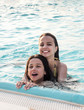 Two young attractive girls in the pool.
