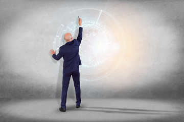Poster - internatibusinessman in front of a wall with a globe communication displayed on a futuristic interfa