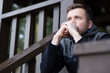 © RealPeopleStudio - A young man sits on the street and thinks about problems. He is in constant stress.