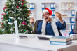 © Elnur - Businessman celebrating christmas holiday in the office