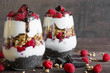 raspberry yogurt parfait in glasses with chocolate, granola and chia seeds