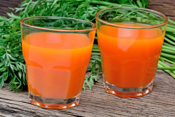 Wall Mural - Carrot juice in a glasses on table