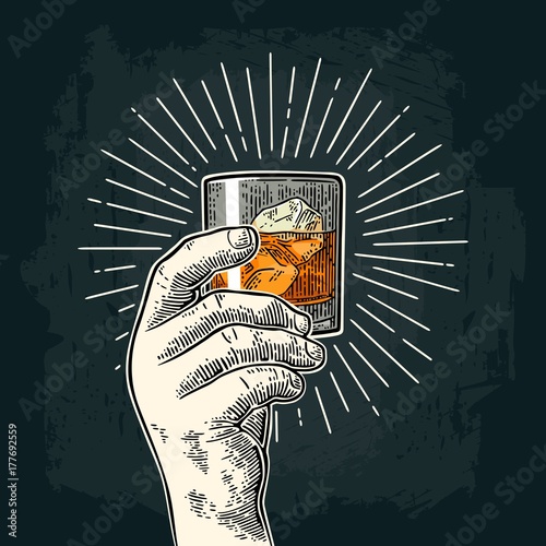 Cuadros en Lienzo Male hand holding glass whiskey with ray