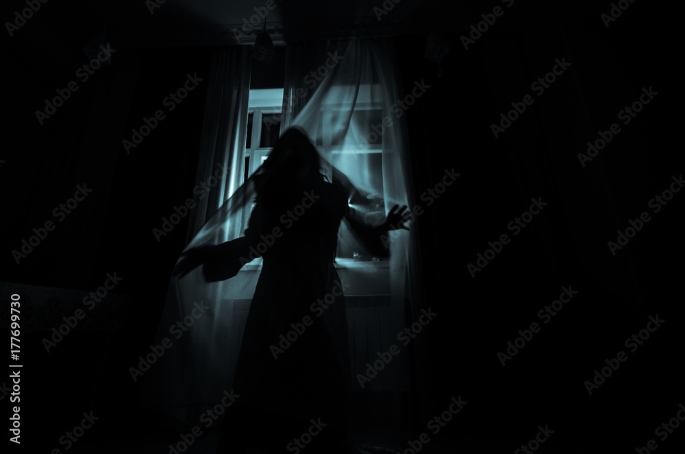Horror woman in window wood hand hold cage scary scene halloween concept Blurred silhouette of witch. Selective focus - obrazy, fototapety, plakaty 