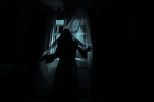 Horror Woman In Window Wood Hand Hold Cage Scary Scene Halloween Concept Blurred Silhouette Of Witch. Selective Focus