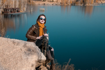 girl on a background of nature and water in autumn