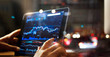 © ipopba - Businessman checking stock market data on tablet on night background