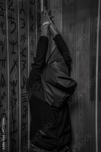 A Man With His Hands Tied Hanging From The Ceiling Kaufen