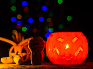 Wall Mural - Halloween pumpkin with bokeh lights background, scary smile. Light inside.