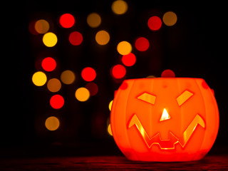 Wall Mural - Halloween pumpkin with bokeh background, scary smile. Halloween holiday concept.