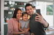 © ReeldealHD images - Family taking a selfie with a smartphone