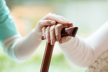 Sticker - Senior holds hands on walking stick