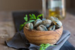 Wooden Bowl full of clams live, ready to be cooked.