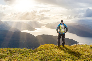 Aufkleber - Man reaching summit enjoying freedom. Stunning view to coastal mountains and fjords. Hellandsnuten, Sandsfjord, Norway.