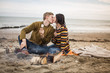 © ReeldealHD images - Young couple kissing by camp fire