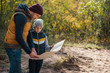 © LIGHTFIELD STUDIOS - father and son with map in forest