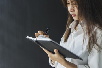 Fototapete - female hands with pen writing on notebook