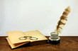 Desk with old books, pince-nez and inkwell