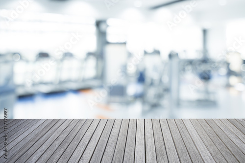 Empty Top Of Wooden Table And Blurred Of Fitness Gym Background