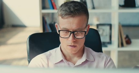 Close-up of man face tired of removing glasses in the office programmer designer leader business manager software engineer internet chat networking communication Slow Motion Shot