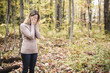 © Louis-Paul Photo - A Sad woman in park during autumn weather hiding face in hand, feeling terrible depressed.